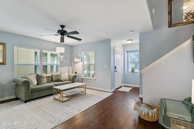 living room featuring hardwood / wood-style floors and ceiling fan