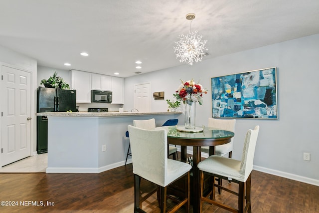 dining room featuring a chandelier and dark wood-type flooring