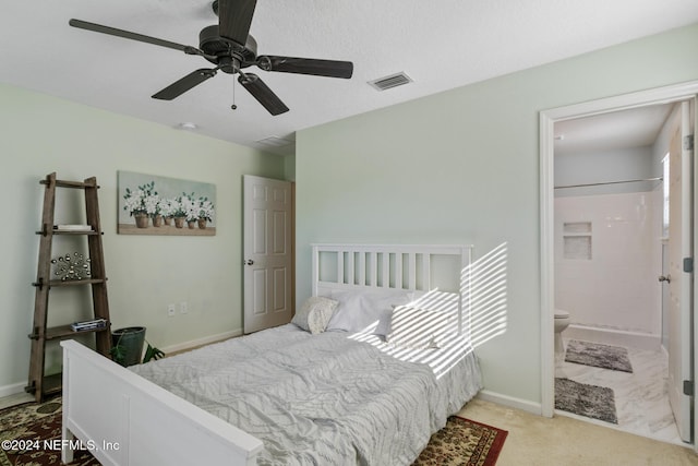 carpeted bedroom with ceiling fan and connected bathroom