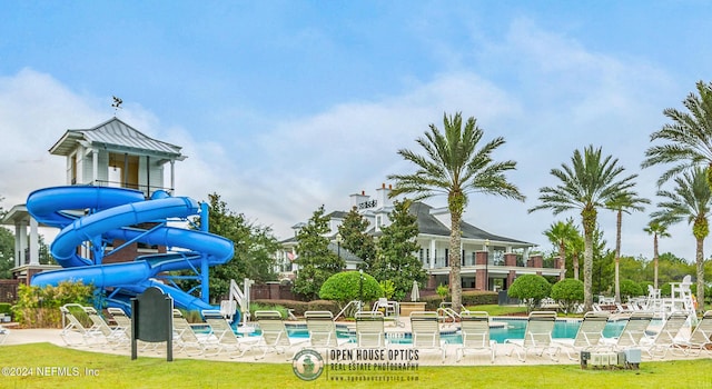 view of playground with a patio and a community pool