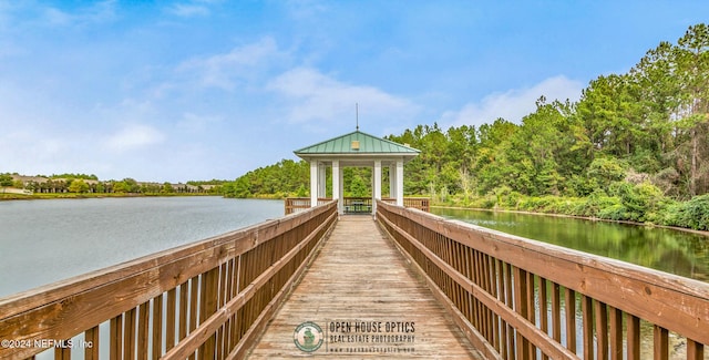 view of dock with a gazebo and a water view