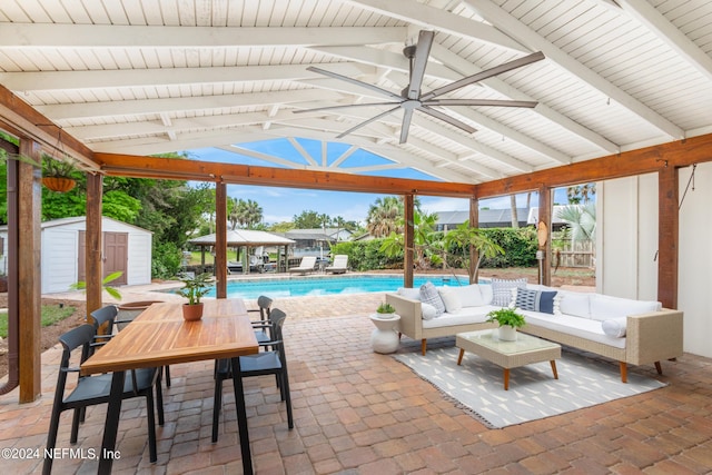 view of patio with a gazebo, outdoor lounge area, and a storage shed