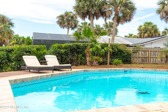 view of swimming pool with glass enclosure