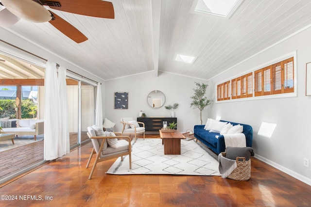 living room featuring ceiling fan, wooden ceiling, and lofted ceiling with skylight