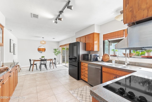 kitchen with light tile patterned floors, sink, track lighting, and black appliances