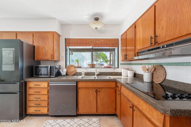 kitchen with sink, stainless steel appliances, range hood, backsplash, and light tile patterned flooring