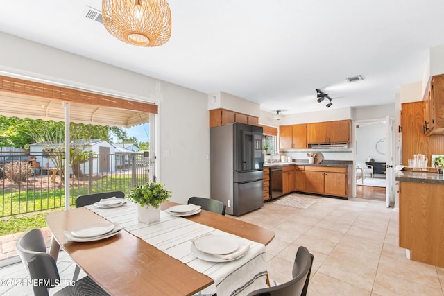 dining space featuring light tile patterned floors and sink