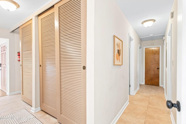 corridor featuring light tile patterned floors