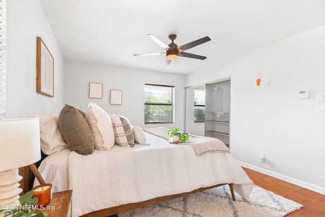 bedroom with hardwood / wood-style floors, a closet, and ceiling fan