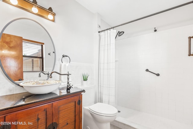 bathroom with walk in shower, vanity, tile walls, and toilet