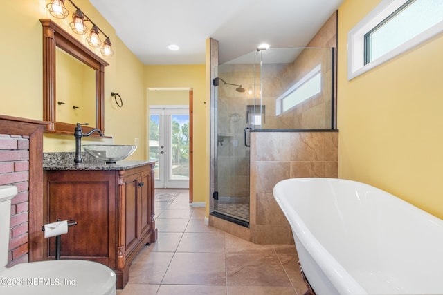 bathroom featuring tile patterned floors, vanity, separate shower and tub, and french doors