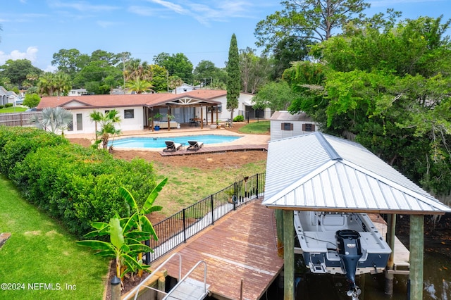 view of dock featuring a yard, a water view, and a patio