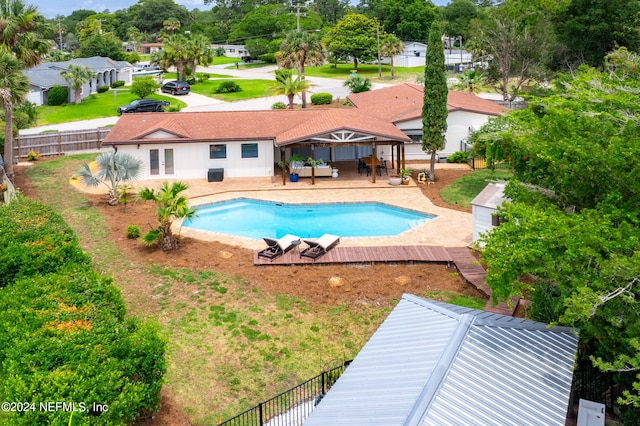 view of swimming pool featuring french doors and a patio area