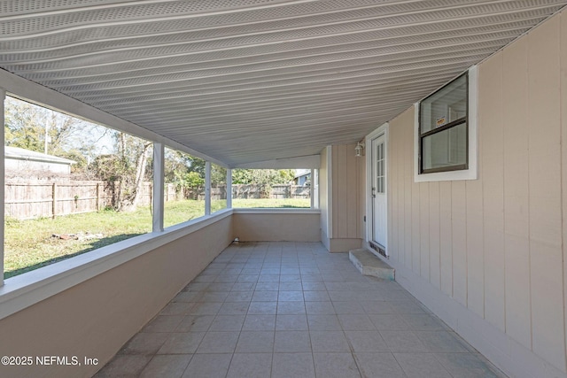 unfurnished sunroom with lofted ceiling