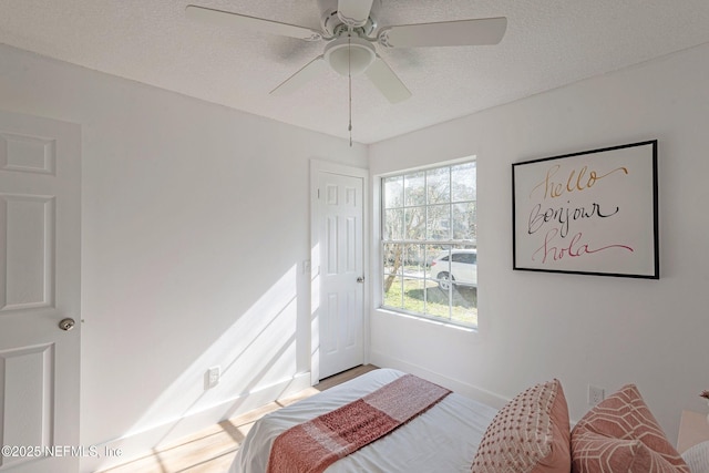 bedroom featuring a textured ceiling and ceiling fan