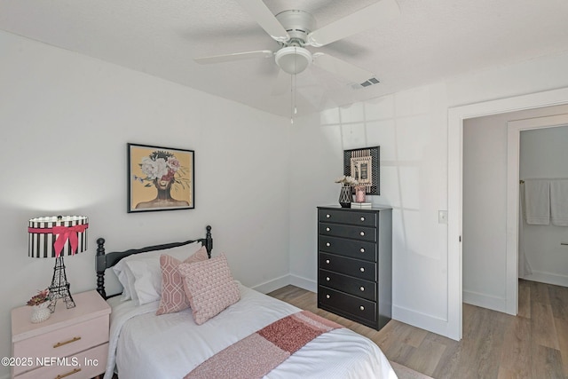 bedroom with ceiling fan and wood-type flooring