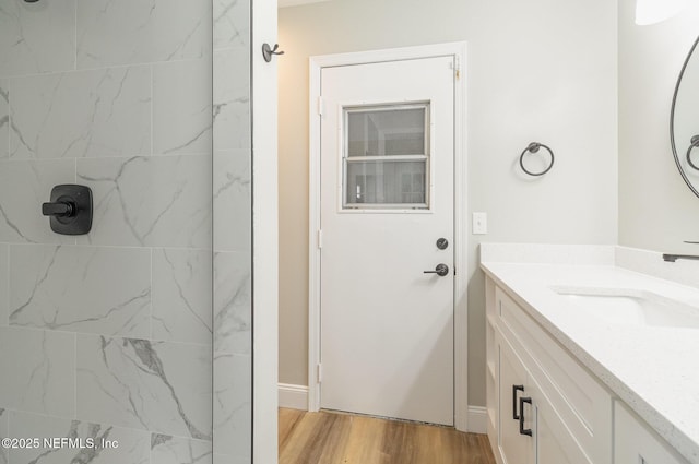 bathroom with hardwood / wood-style flooring and vanity