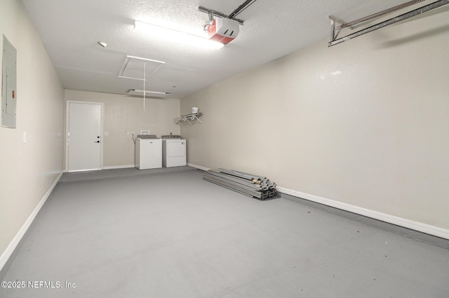 garage with washer and clothes dryer and a garage door opener