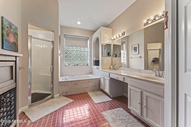 bathroom featuring tile patterned flooring, vanity, a textured ceiling, and independent shower and bath