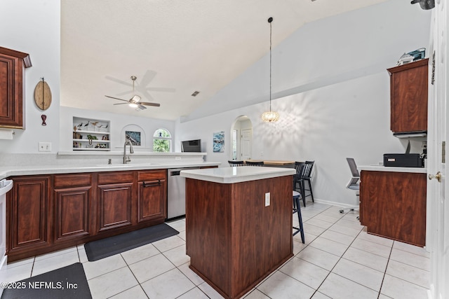 kitchen with sink, vaulted ceiling, stainless steel dishwasher, built in features, and a kitchen island