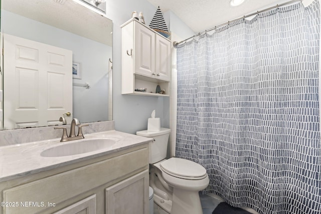 bathroom featuring vanity, a textured ceiling, toilet, and a shower with shower curtain