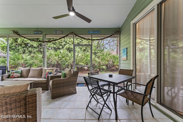 sunroom / solarium featuring lofted ceiling, ceiling fan, and a healthy amount of sunlight