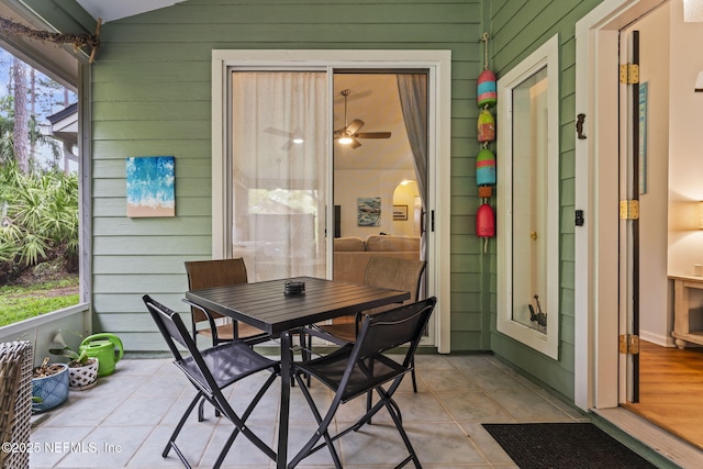 sunroom featuring ceiling fan and lofted ceiling