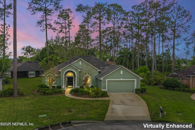 ranch-style home with a lawn and a garage