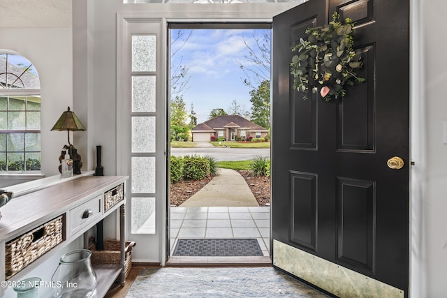 entrance foyer with a textured ceiling and light hardwood / wood-style flooring