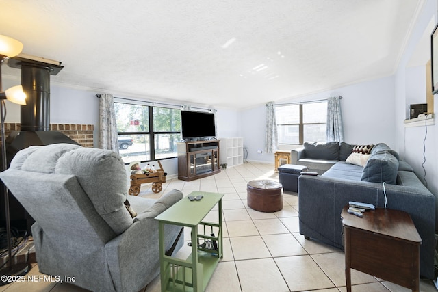 tiled living room featuring a wealth of natural light, crown molding, and a textured ceiling