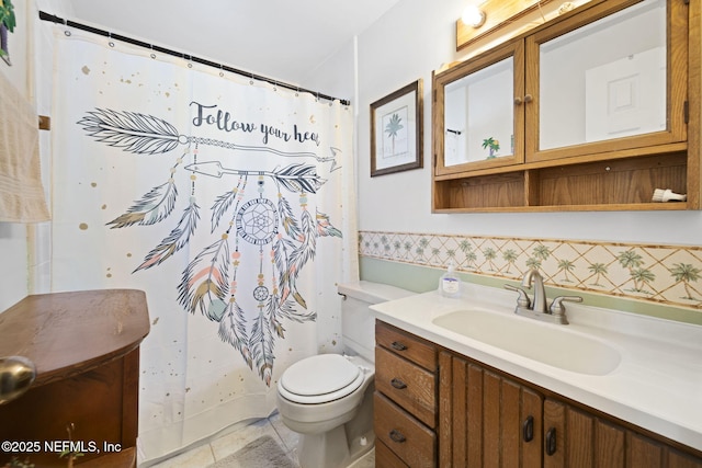 bathroom featuring tile patterned floors, walk in shower, vanity, and toilet