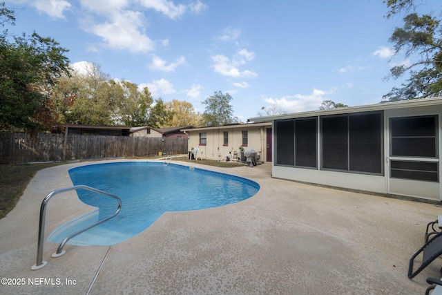 view of pool featuring a patio and a sunroom