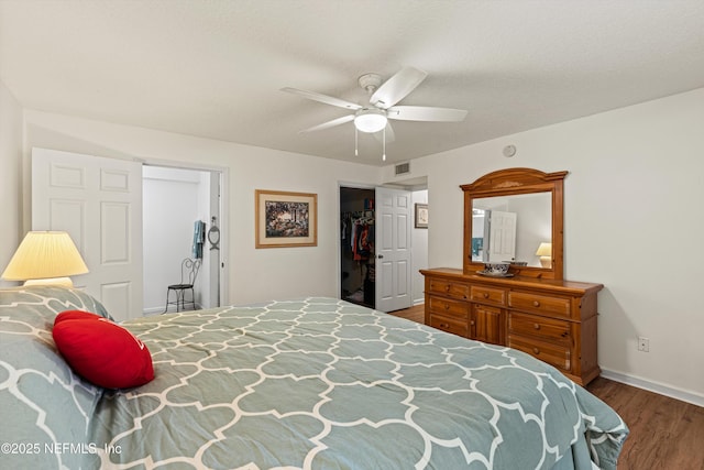 bedroom featuring hardwood / wood-style floors, ceiling fan, a textured ceiling, and a closet