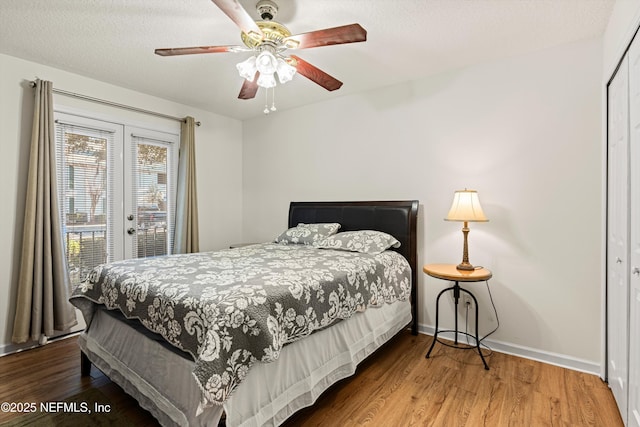 bedroom featuring a closet, ceiling fan, hardwood / wood-style floors, and a textured ceiling