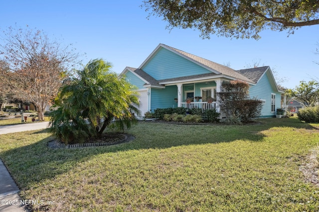 view of front of property with covered porch, a garage, and a front lawn