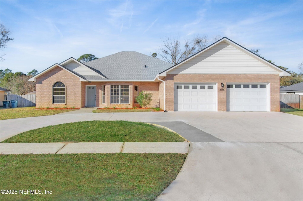 ranch-style house with a front yard and a garage