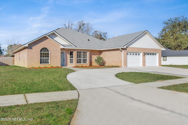 ranch-style home featuring a front lawn and a garage