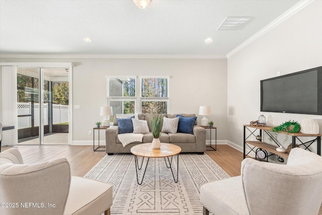 living room with light hardwood / wood-style floors and crown molding