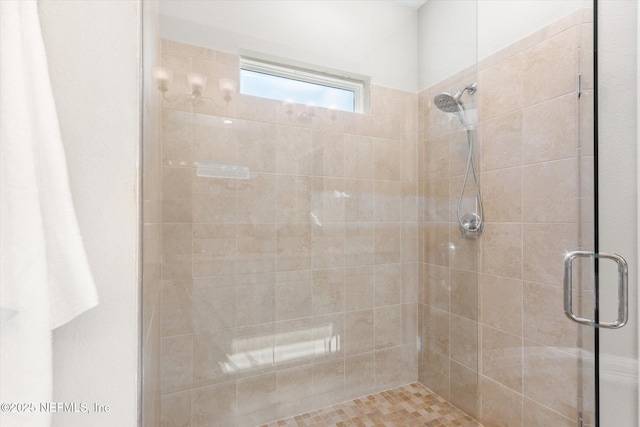 bathroom with a shower with door