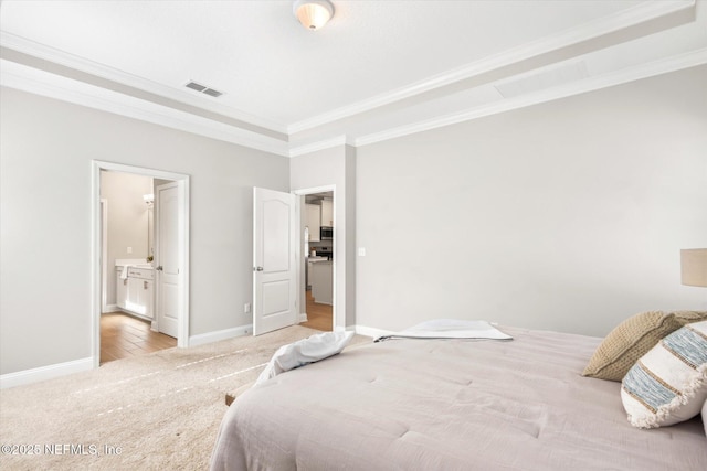 bedroom with ensuite bathroom, light colored carpet, and ornamental molding