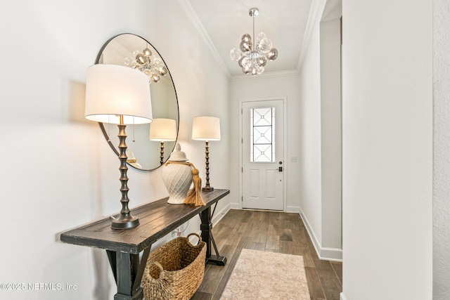 entryway with an inviting chandelier, crown molding, and dark hardwood / wood-style floors