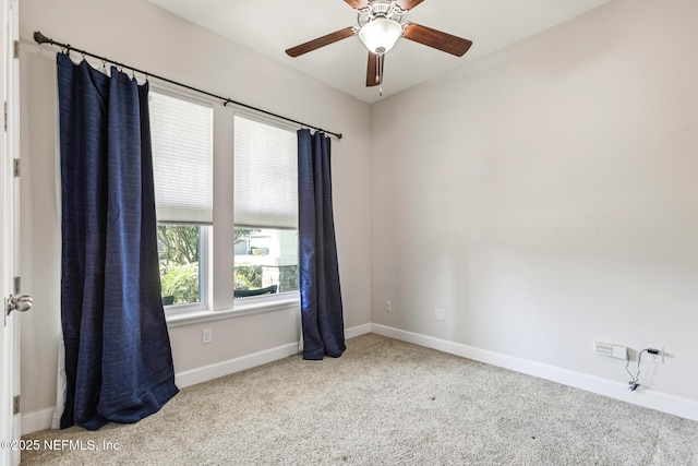 empty room with ceiling fan and carpet flooring