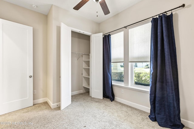 unfurnished bedroom with ceiling fan, light colored carpet, and a closet