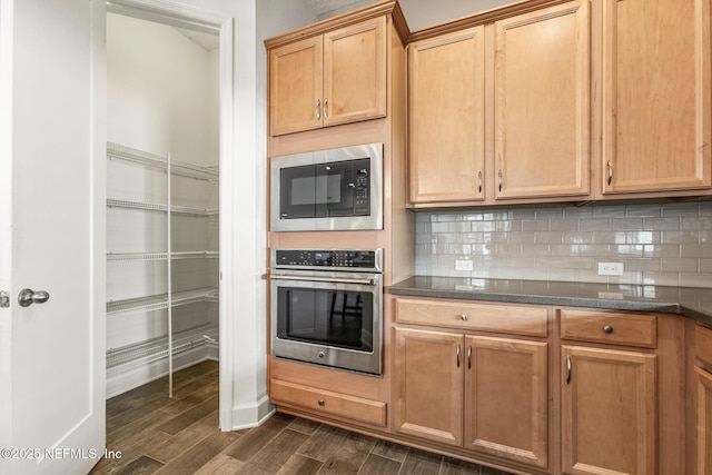 kitchen with tasteful backsplash, built in microwave, and oven