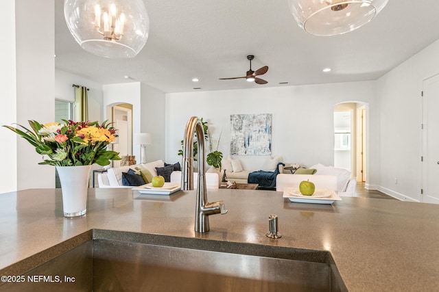 interior space with ceiling fan and sink