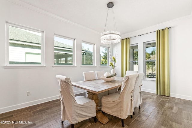 dining area featuring crown molding, a wealth of natural light, and an inviting chandelier