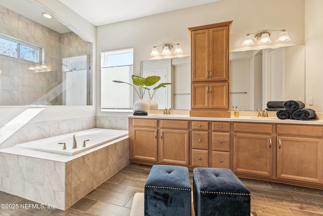 bathroom with tiled bath and vanity