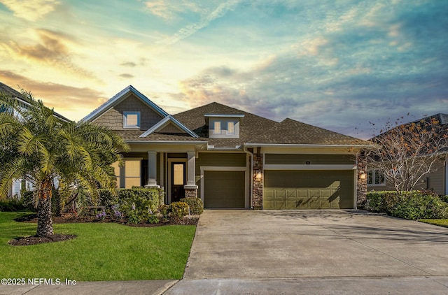 view of front facade with a garage and a lawn