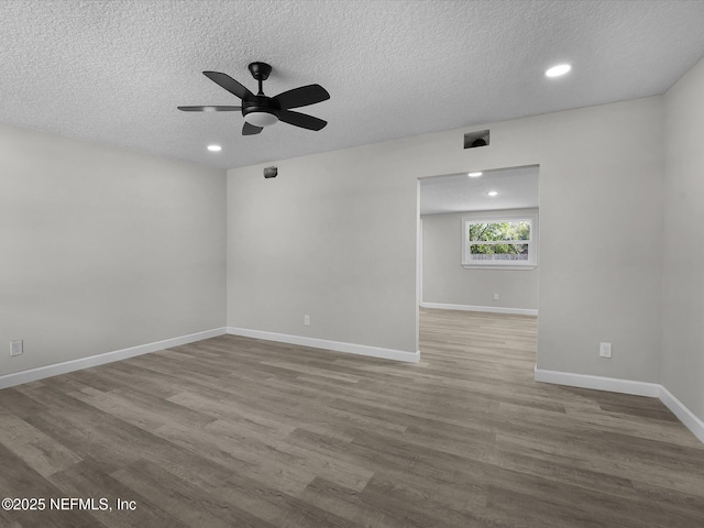 unfurnished room featuring ceiling fan, light hardwood / wood-style floors, and a textured ceiling