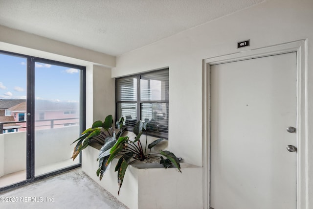 interior space with concrete floors and a textured ceiling